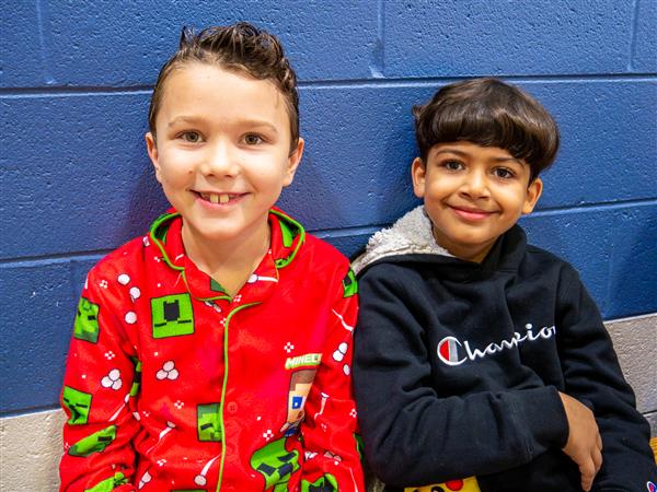 Students in holiday clothes doing festive things at school. 